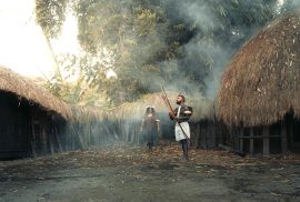 Gambar 1. Masyarakat di desa adat. (Sumber: https://www.pexels.com/photo/traditional-indigenous-village-scene-with-tribal-people-32696007/)